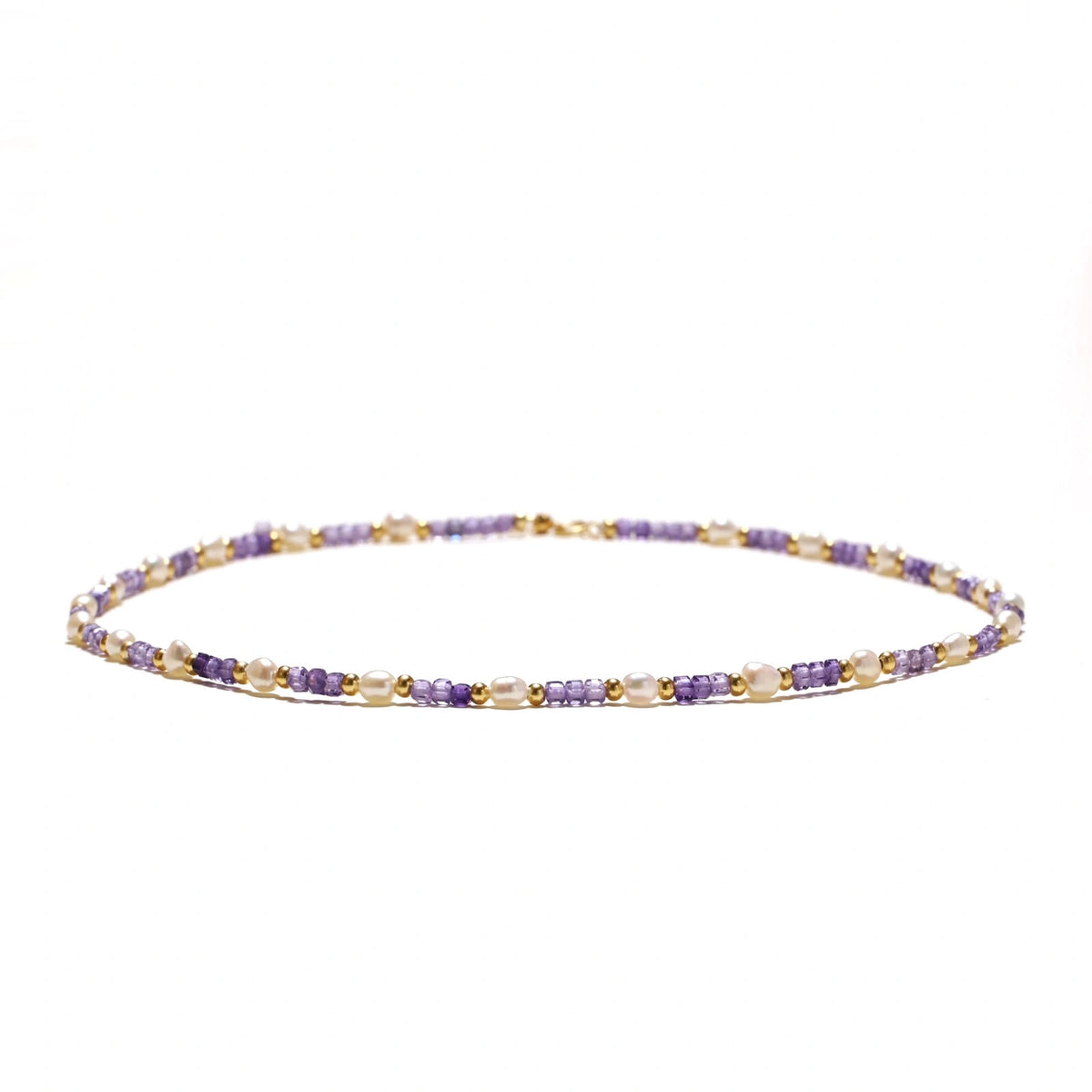 Delicate 18K gold vermeil necklace with alternating lavender zirconia beads and white freshwater pearls on cream background
