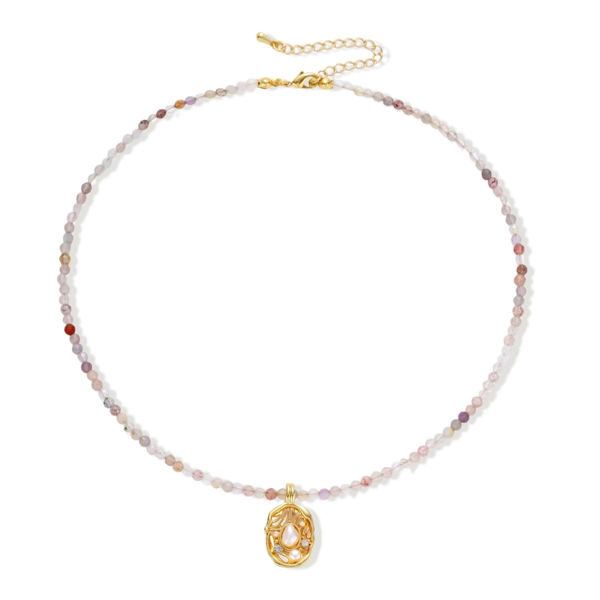 Delicate gold-plated necklace with mixed gemstone beads and ornate oval pendant on white background