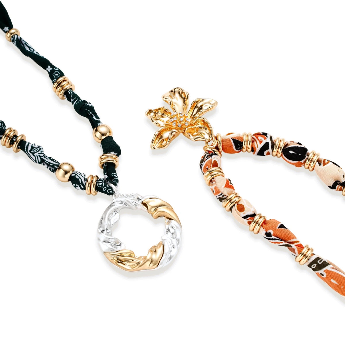 Adjustable necklace with black paisley fabric cord, gold metal spacers, and clear twisted pendant on cream background