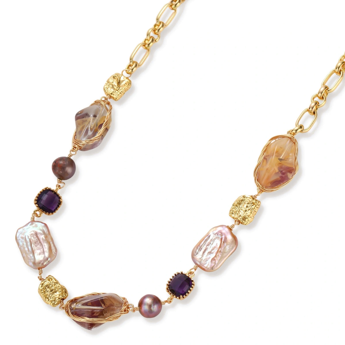 Gold-plated necklace with baroque pearls, purple amethyst stones, and wire-wrapped details on white background.