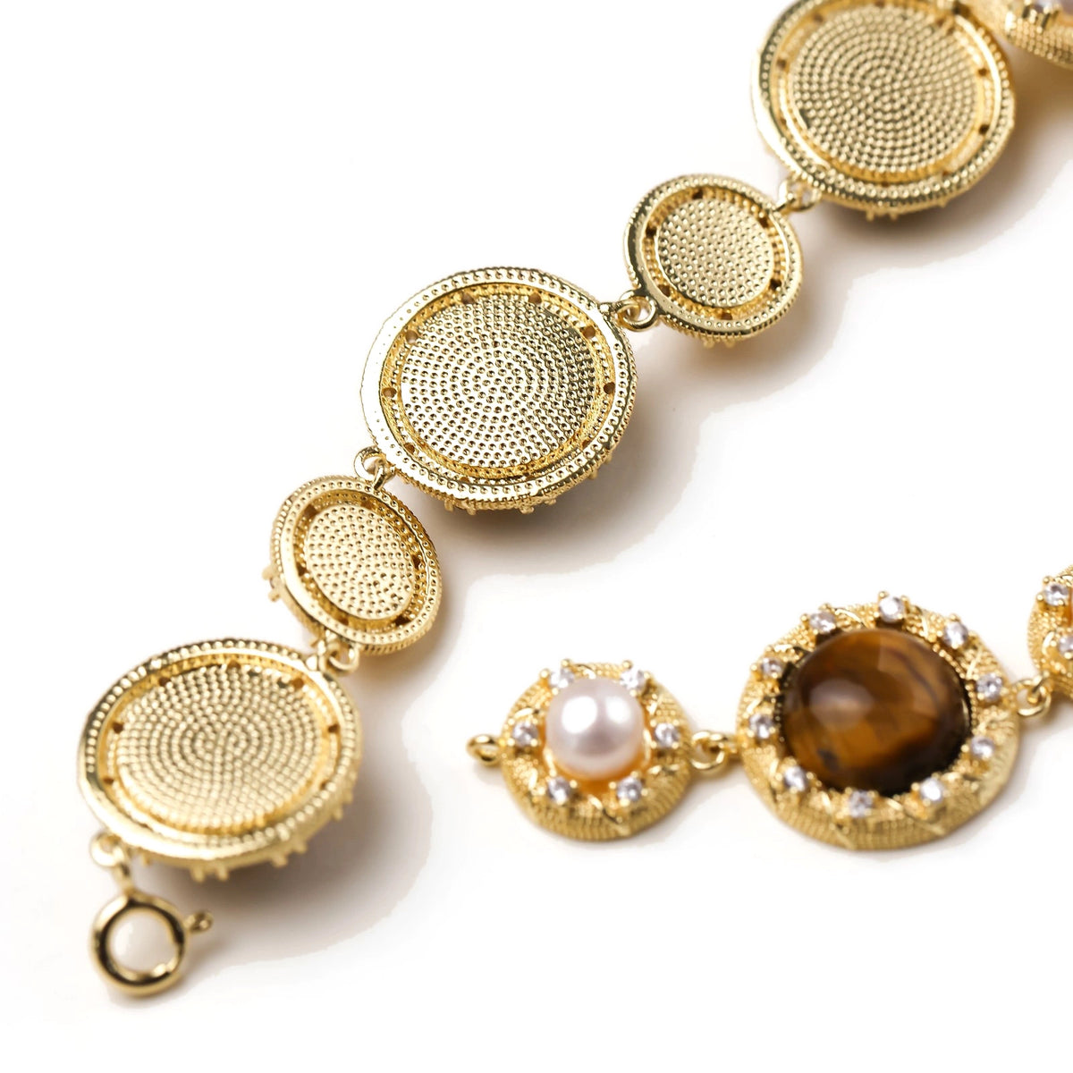Gold-plated link bracelet with alternating brown tiger's eye stones and white freshwater pearls in ornate bezels.
