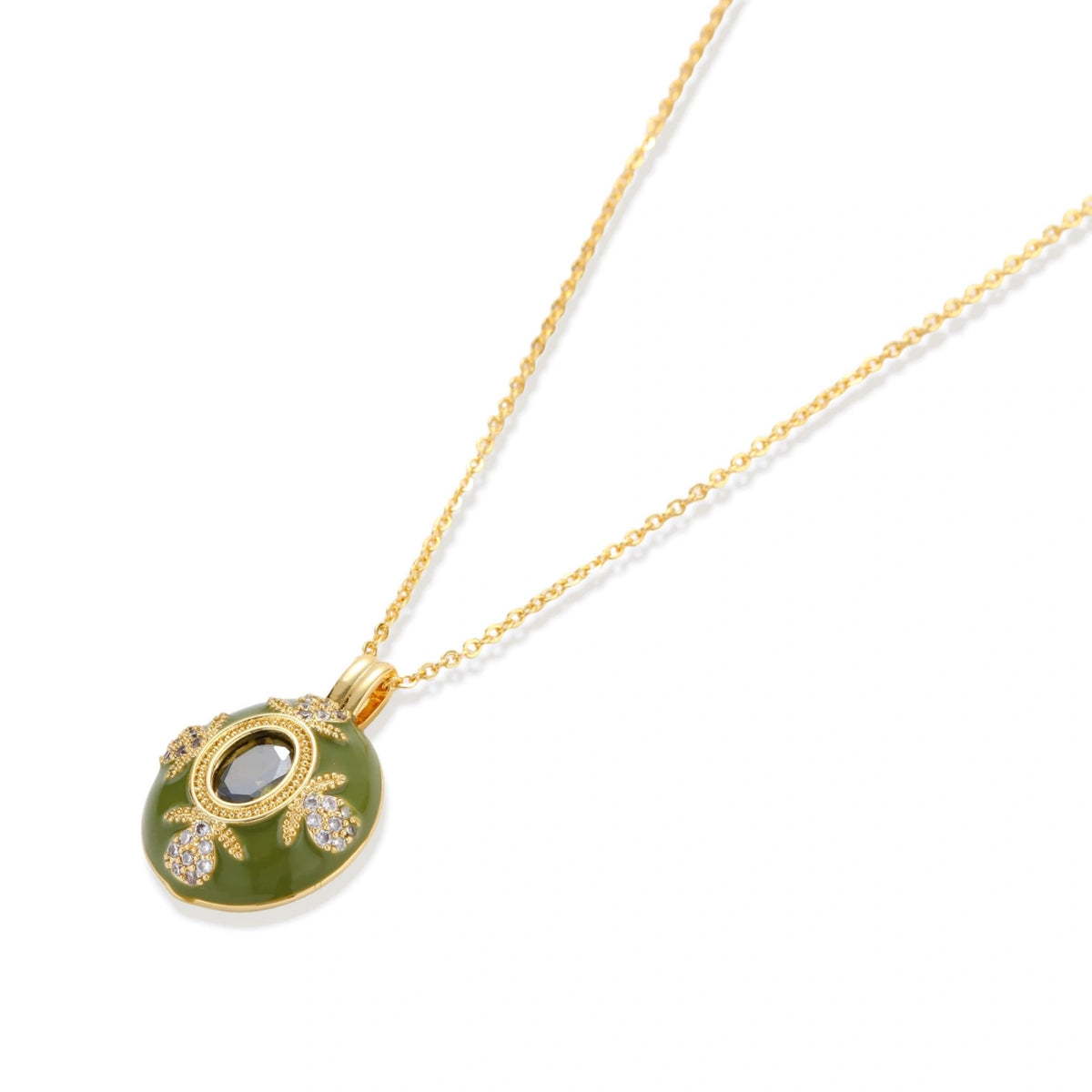 Gold-plated pendant necklace with green enamel background and oval olive cubic zirconia center stone with crystal accents.