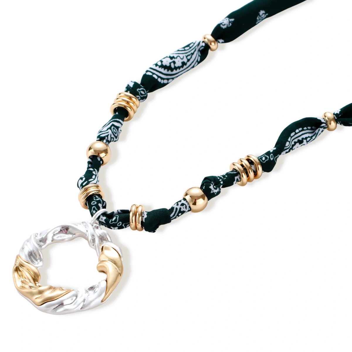 Adjustable necklace with black paisley fabric cord, gold metal spacers, and clear twisted pendant on cream background