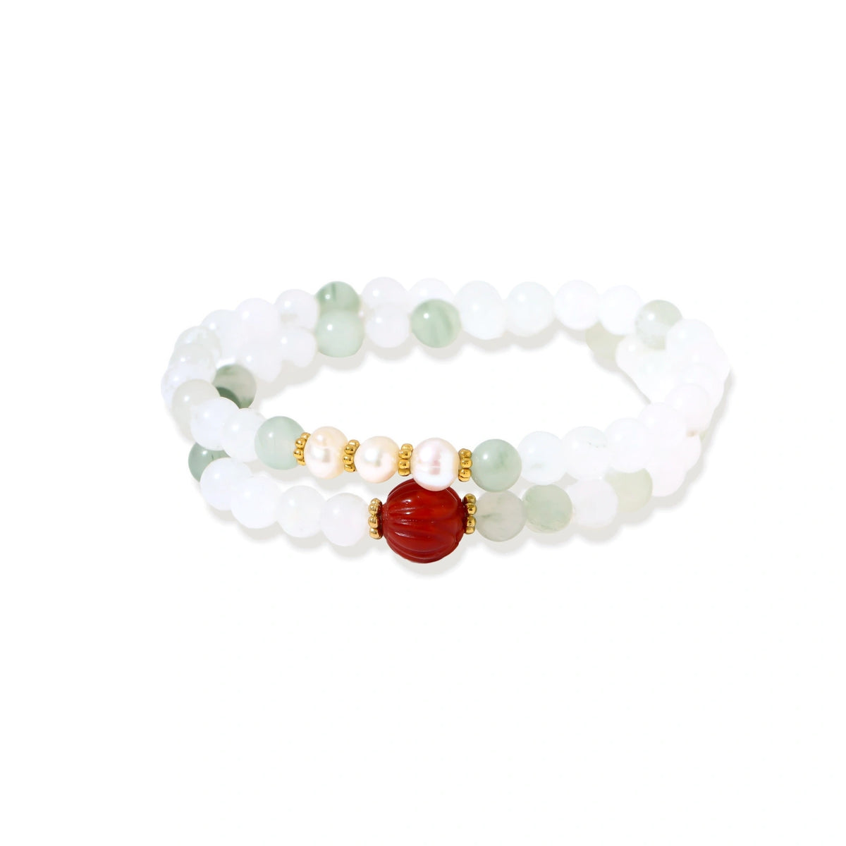Three layered white beaded bracelets with carved orange agate lotus centerpiece and freshwater pearls on cream background.