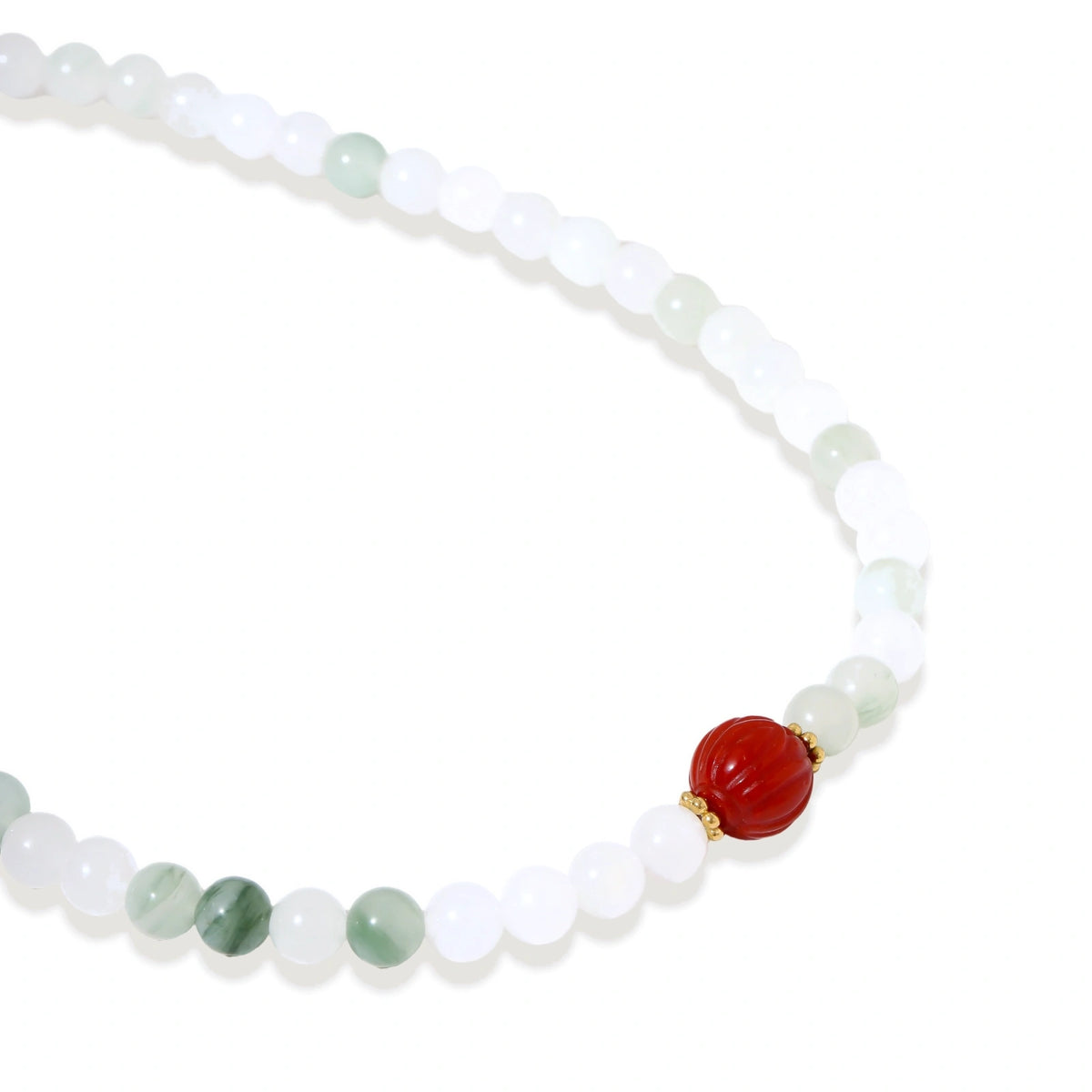 Three layered white beaded bracelets with carved orange agate lotus centerpiece and freshwater pearls on cream background.