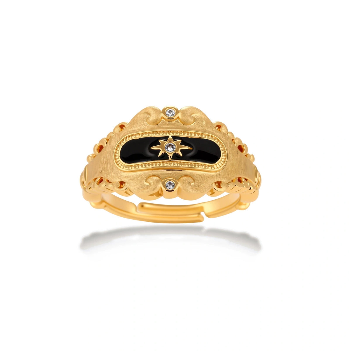 Ornate 18K gold-plated ring with black enamel center featuring star motif and decorative baroque-style edges on white background.